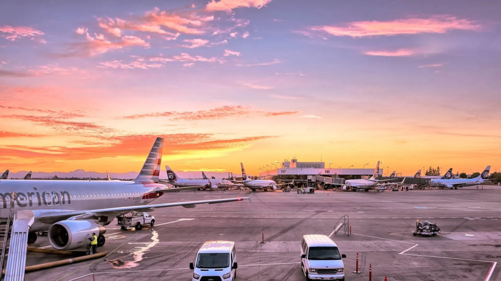 A captivating sunset at a bustling airport, symbolizing the potential for international connectivity when investing in Bulacan real estate.