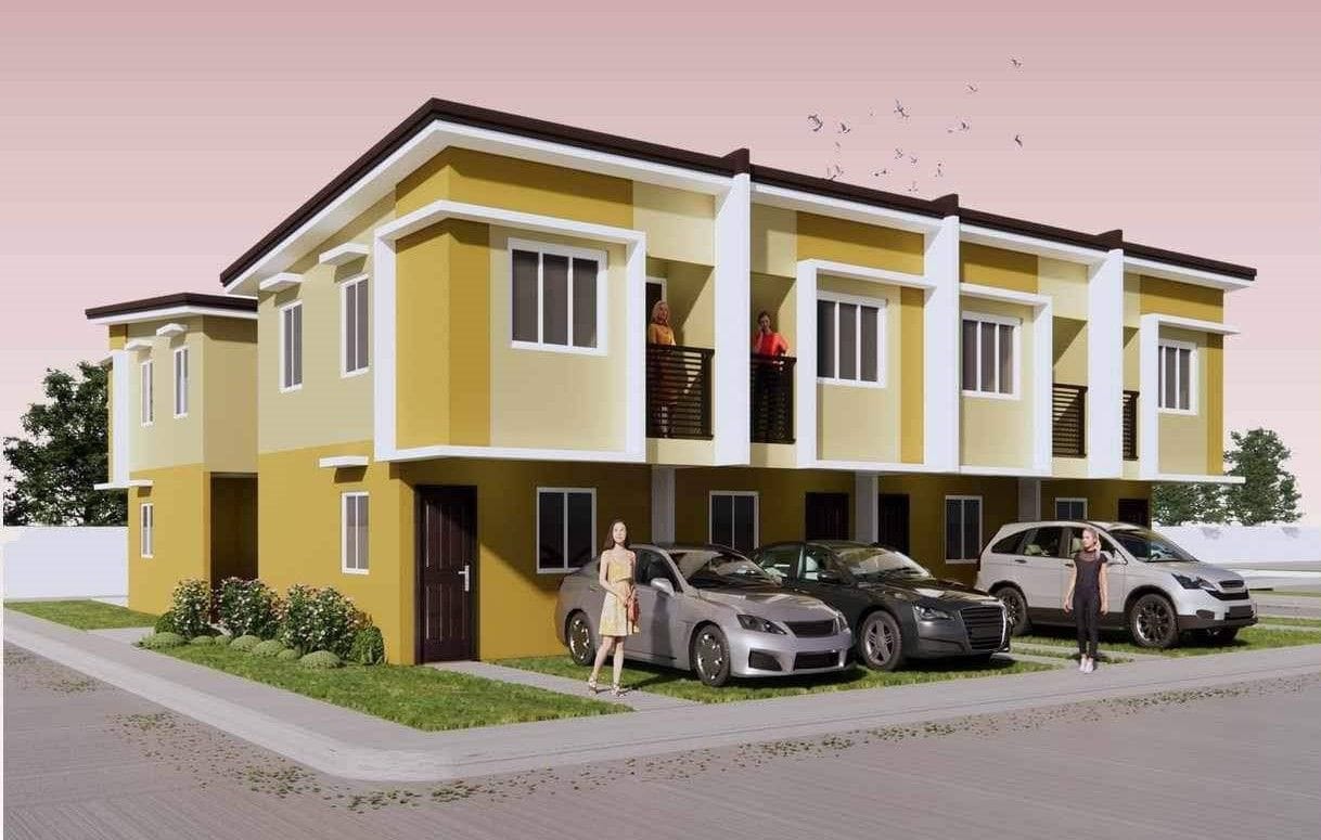Modern townhouse complex at Alora Heights, Santa Maria, Bulacan, featuring a two-story design with a yellow and white color scheme, balconies, and parked cars in front. The scene is set against a pinkish sky with birds flying in the background.